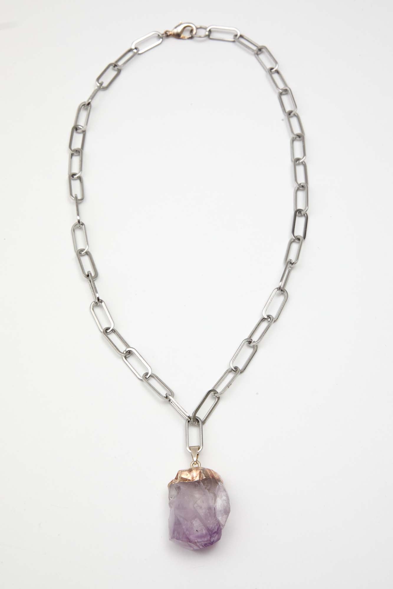 Necklace with a purple pendant on a white background