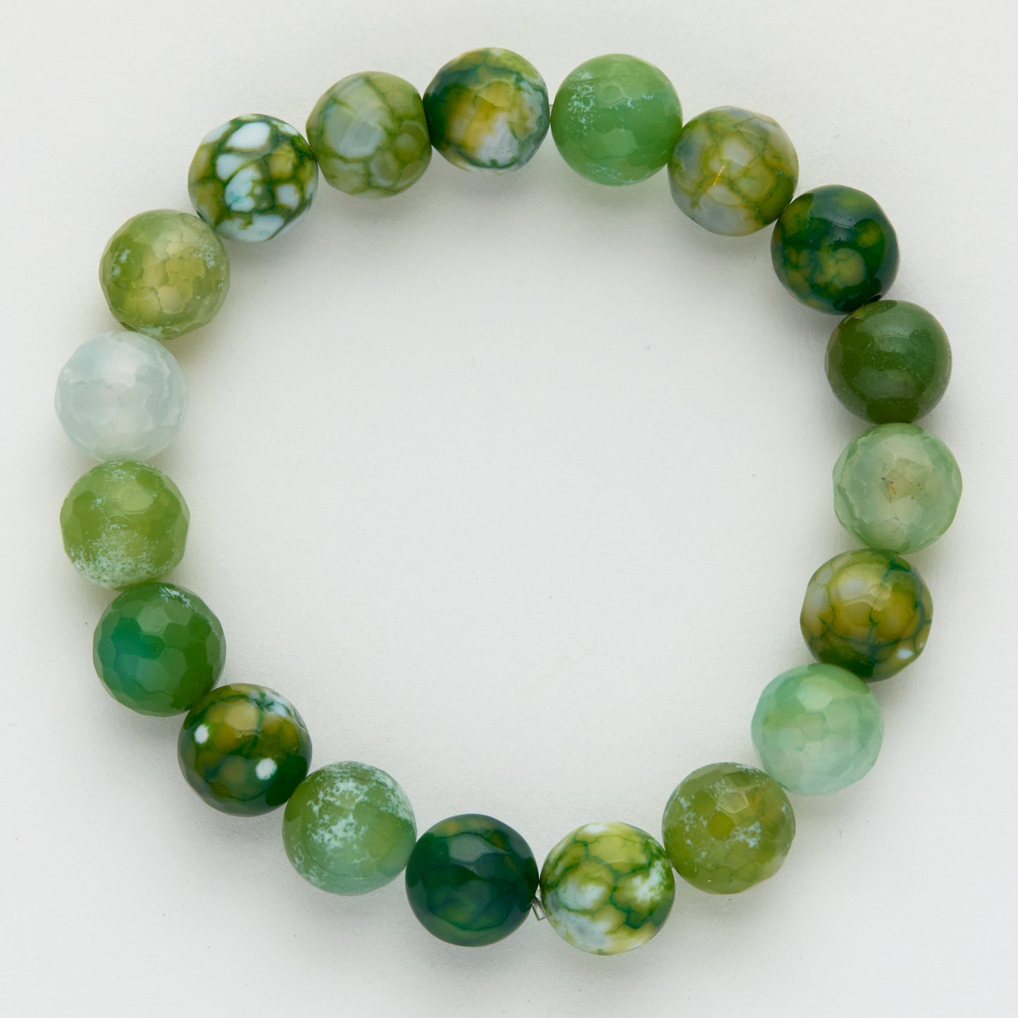 Green and white marbled bead bracelet on a light background