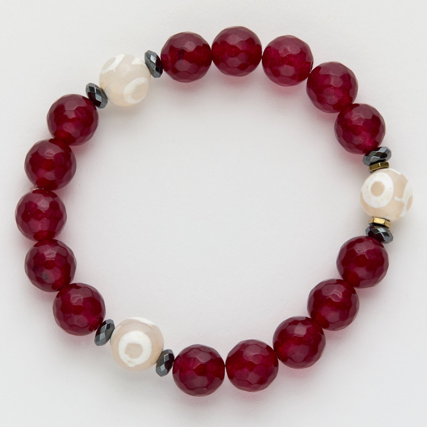 Beaded bracelet with red, white, and black beads on a light background