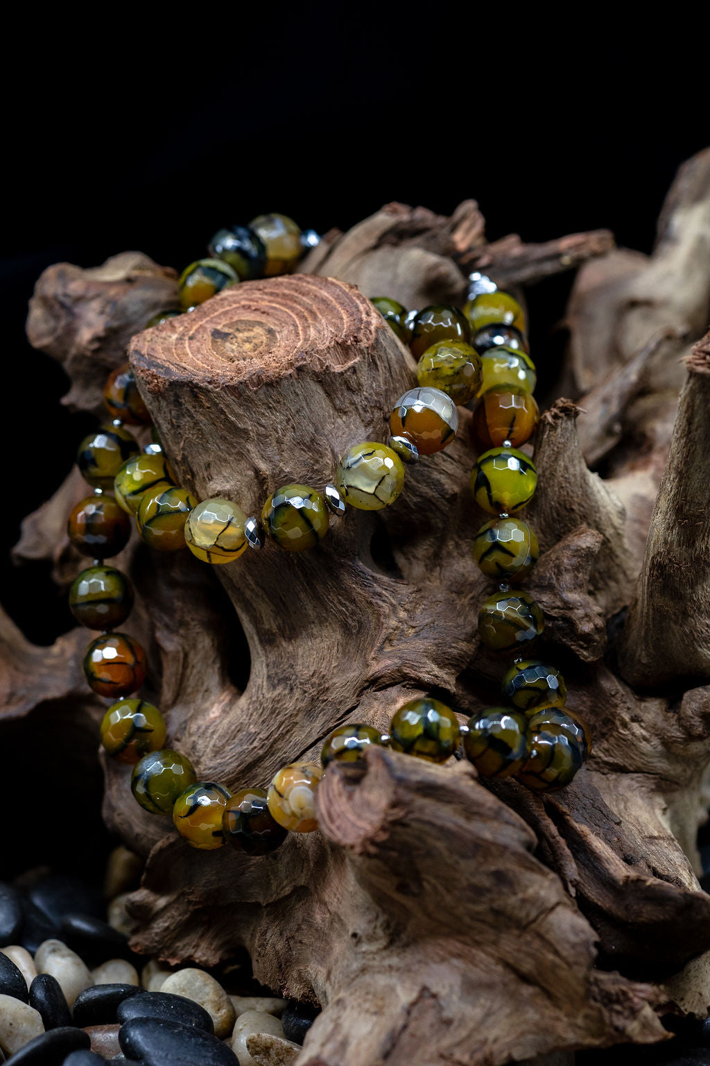 Morgan bracelet and matching Morgan necklace on tree stump against a black background.