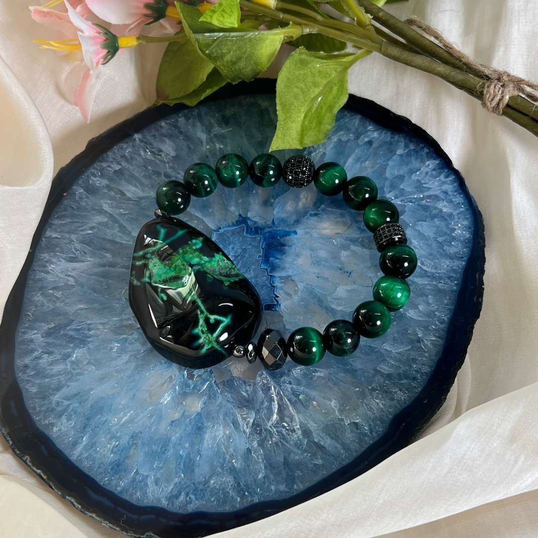 dyed black and green agate focal and dyed green tiger eye bead bracelet on blue agate slab