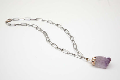 Necklace with a purple pendant on a white background