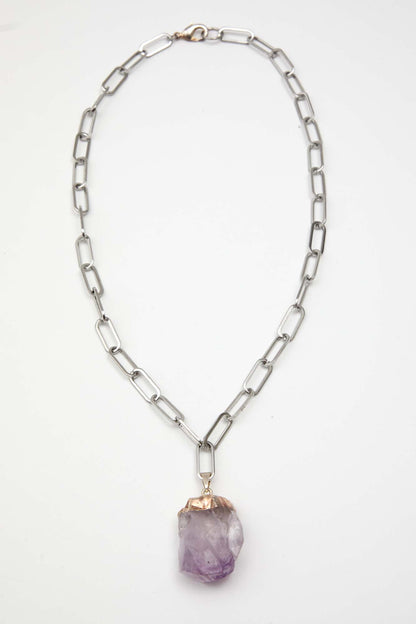 Necklace with a purple pendant on a white background