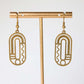 Gold earrings with geometric design on a white background
