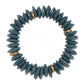 A beaded stretch bracelet made of dark teal-blue Ashanti beads separated by small brass beads, shown on a plain white background.