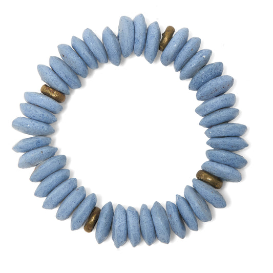 A beaded stretch bracelet made of light blue, Ashanti beads with a few small brass spacer beads, shown on a plain white background.