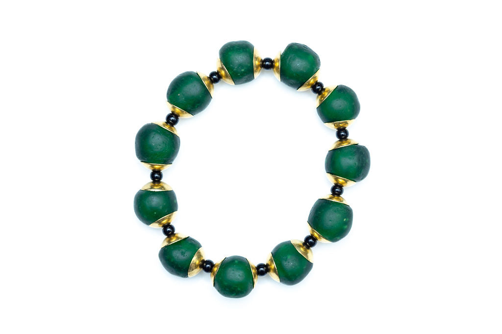 Hunter green bracelet with brass and black accent beads against white background