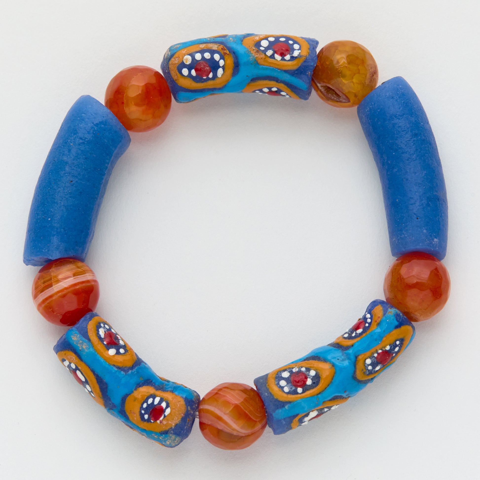 Beaded bracelet with blue and orange beads on a white background