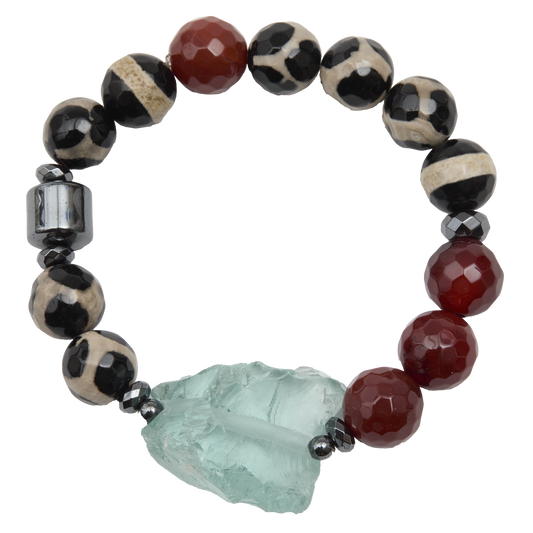 Beaded bracelet with red, black, and white beads and a large green stone on a white background