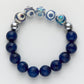 Beaded bracelet with blue beads and silver accents on a white background