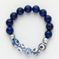 Navy blue beaded bracelet with silver and patterned beads on a white background