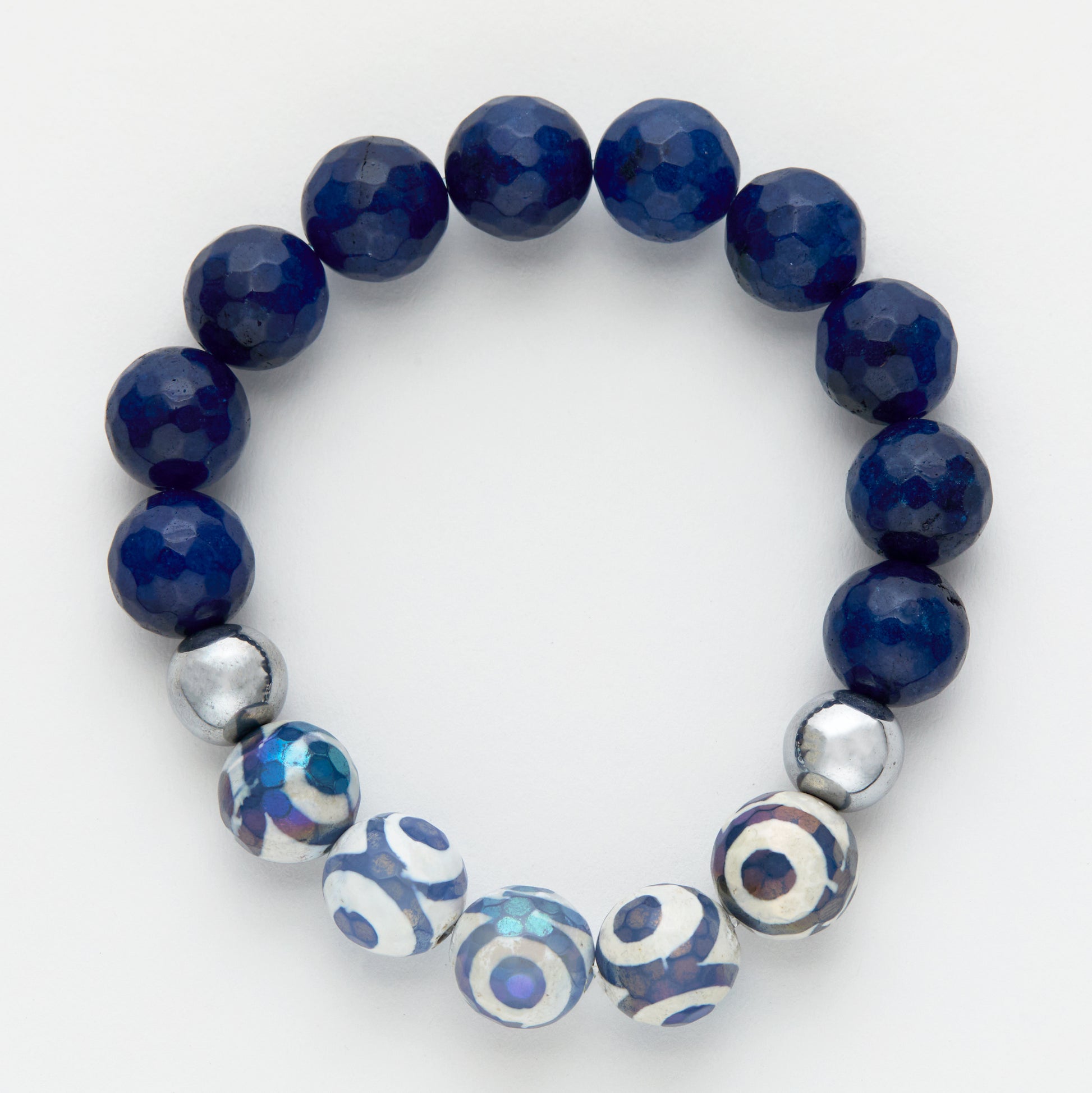 Navy blue beaded bracelet with silver and patterned beads on a white background