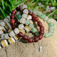 Set of beaded bracelets on a stone with grass in the background