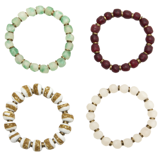 Four beaded bracelets in different colors on a white background