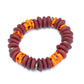 A multicolored bead bracelet with a mix of brown, orange, and yellow hues, featuring brass donut beads and fused rondelle African recycled glass beads against a white background.
