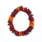 A multicolored bead bracelet with a mix of brown, orange, and yellow hues, featuring brass donut beads and fused rondelle African recycled glass beads against a white background.