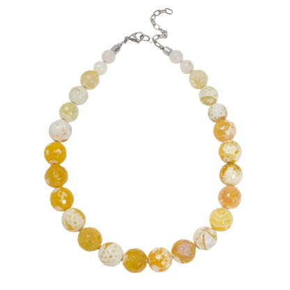 Necklace with yellow and white marbled beads on a white background