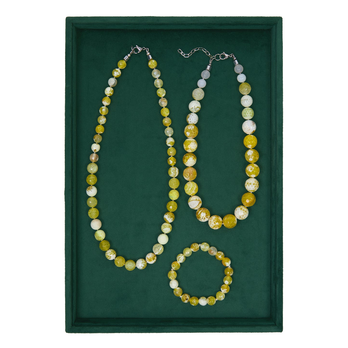 Set of beaded necklace and bracelet on a green background