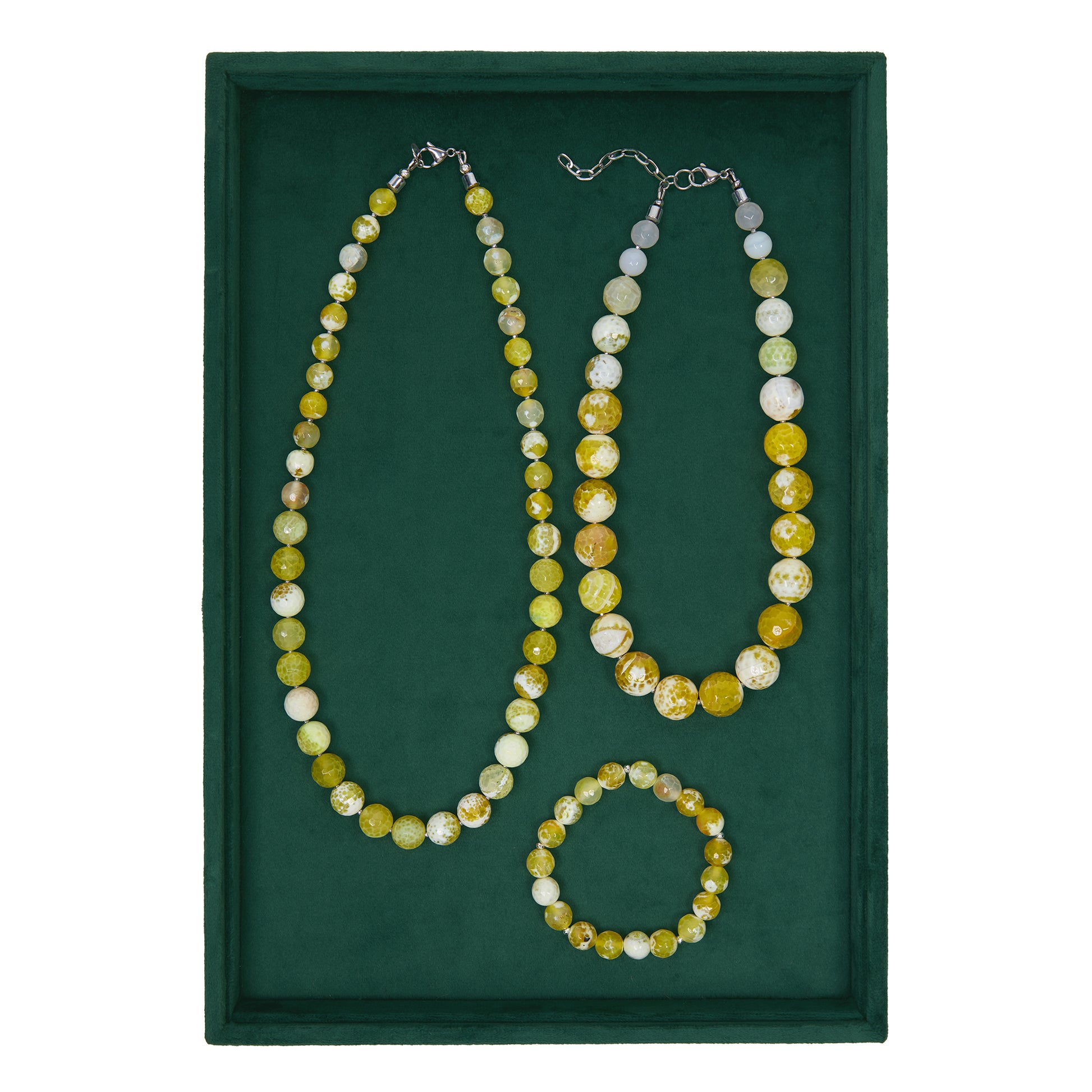 Set of beaded necklace and bracelet on a green background