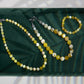 Beaded necklace and bracelet on a green tray