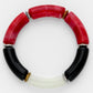 Bracelet with red, black, and gold cylindrical beads on a white background