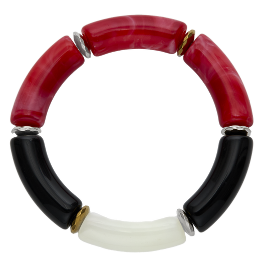 Bracelet with red, black, and white cylindrical beads on a white background