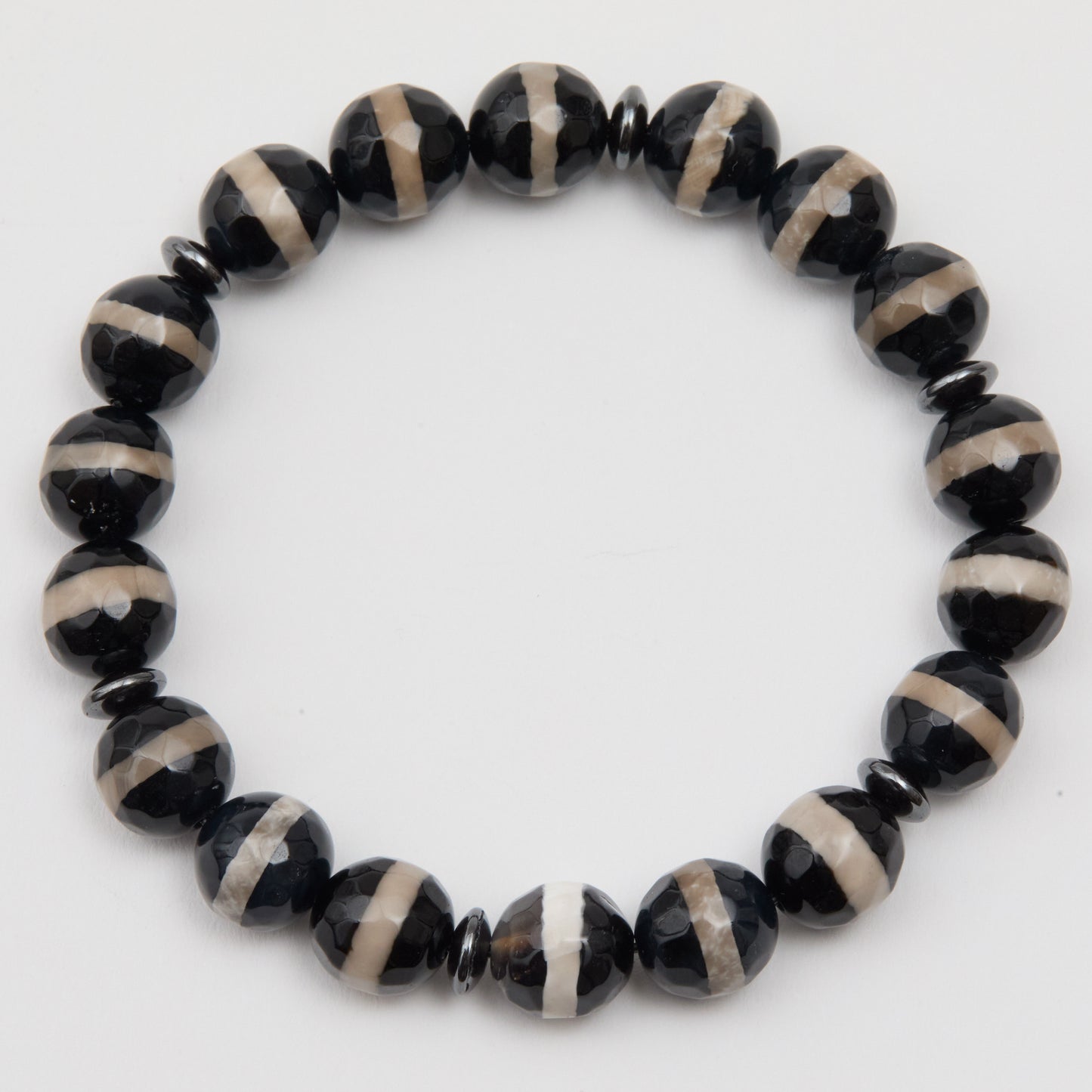 Black and beige beaded bracelet on a white background