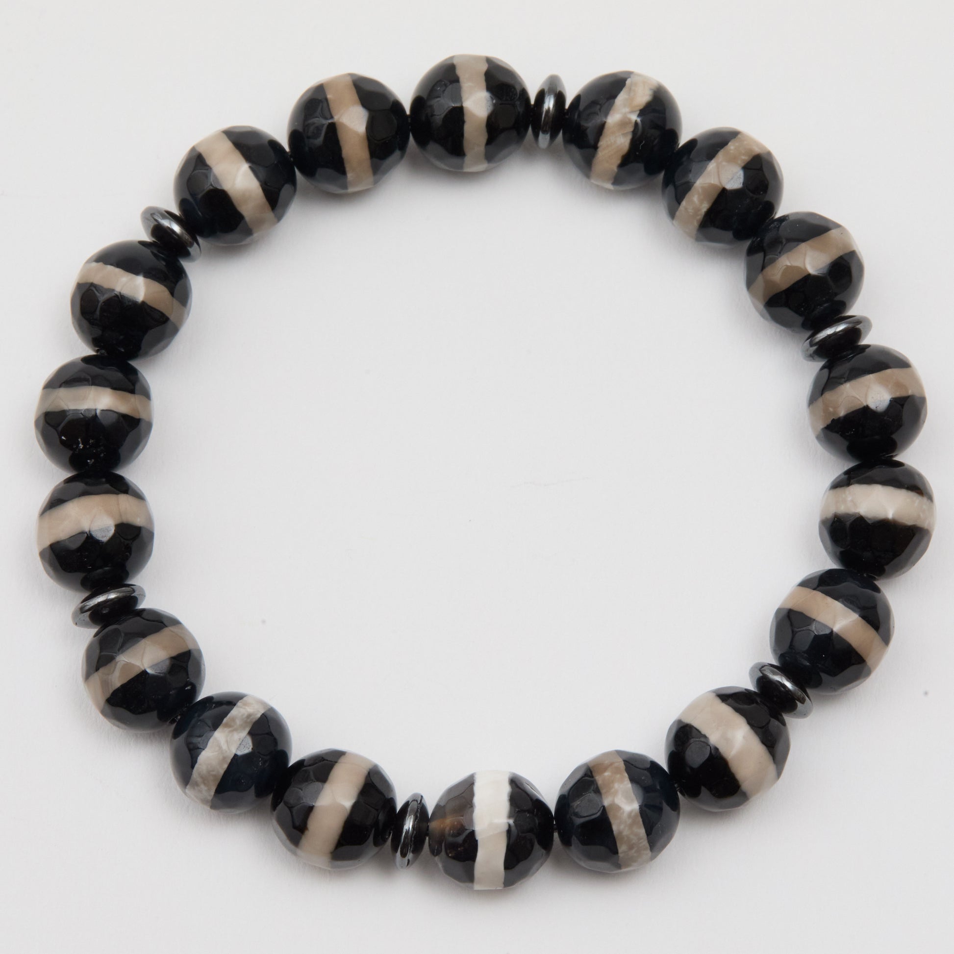 Black and beige beaded bracelet on a white background
