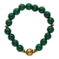 Green beaded bracelet with a gold clasp on a white background