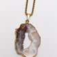 Oco agate geode pendant necklace on a white background
