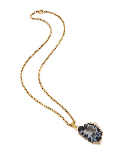 Gold necklace with a pendant on a white background