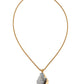 Necklace with a gray stone pendant on a gold chain against a white background