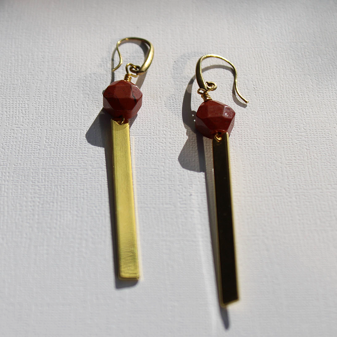 A pair of gold-tone brass earrings with red creek jasper faceted beads.