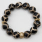 Leopard print beaded bracelet with gold accents on a white background