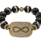 Bracelet with black beads and gold-plated infinity focal  on a white background