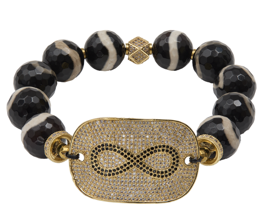 Bracelet with black beads and gold-plated infinity focal  on a white background