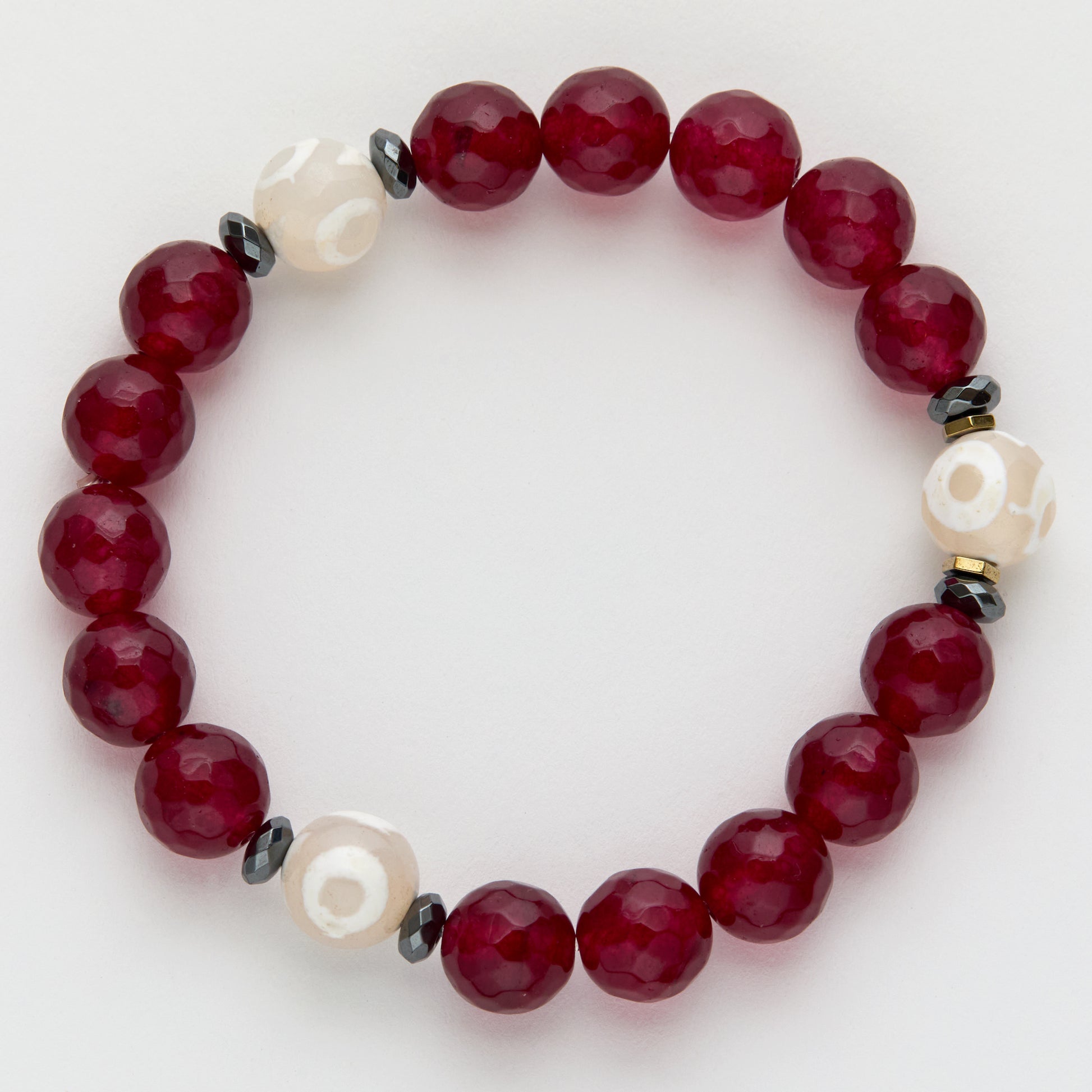 Beaded bracelet with red, white, and black beads on a light background