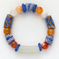 Colorful beaded bracelet with blue, orange, and white beads on a white background