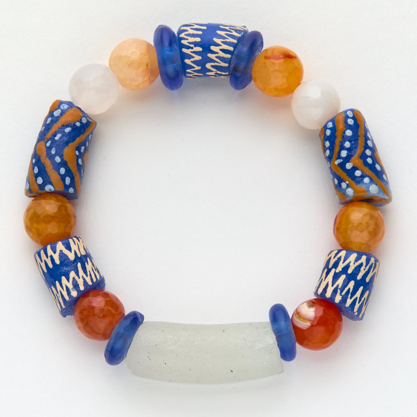 Colorful beaded bracelet with blue, orange, and white beads on a white background