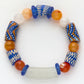 Colorful beaded bracelet with blue, orange, and white beads on a white background