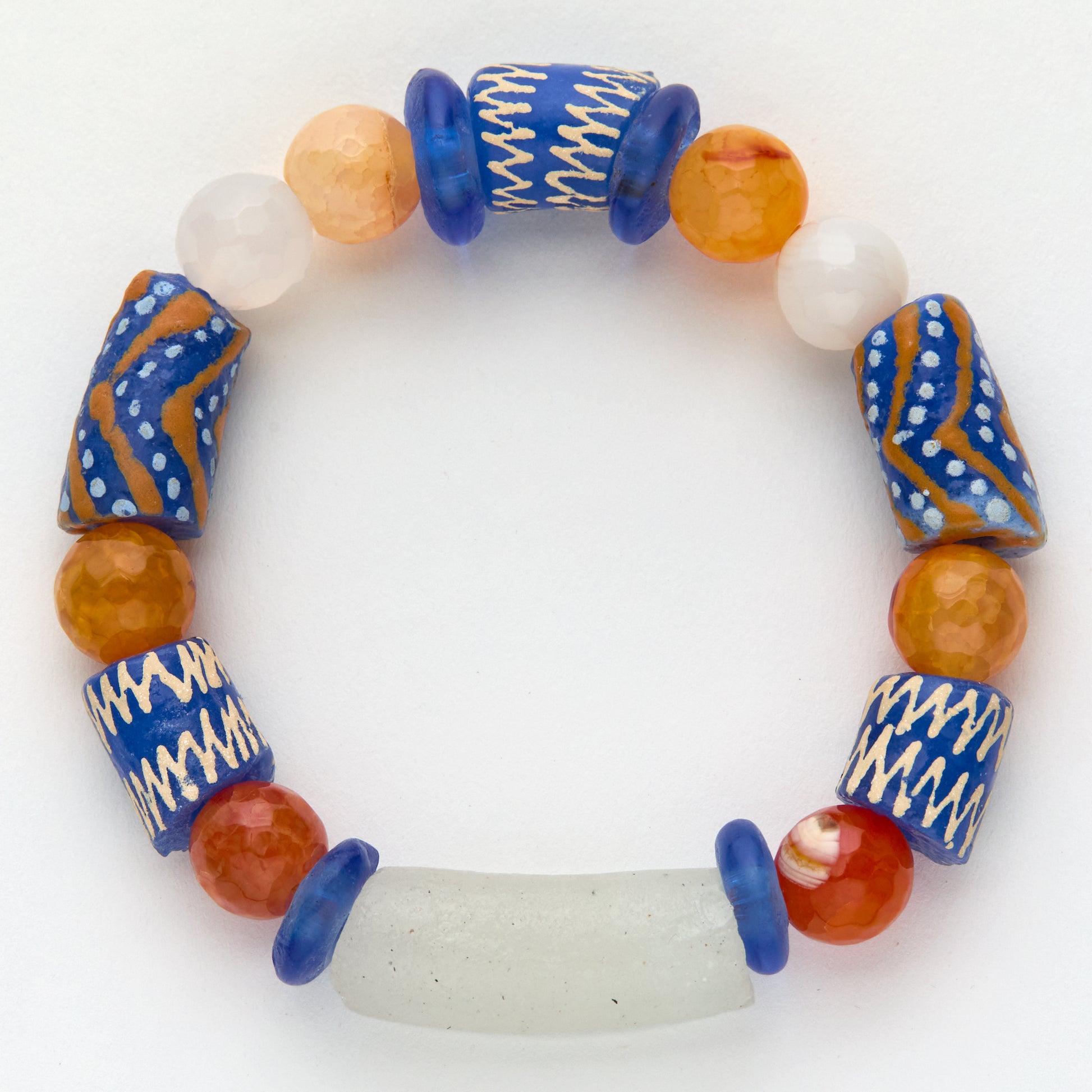 Colorful beaded bracelet with blue, orange, and white beads on a white background