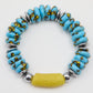 Bracelet with blue beads, yellow accents, and silver accents on a white background