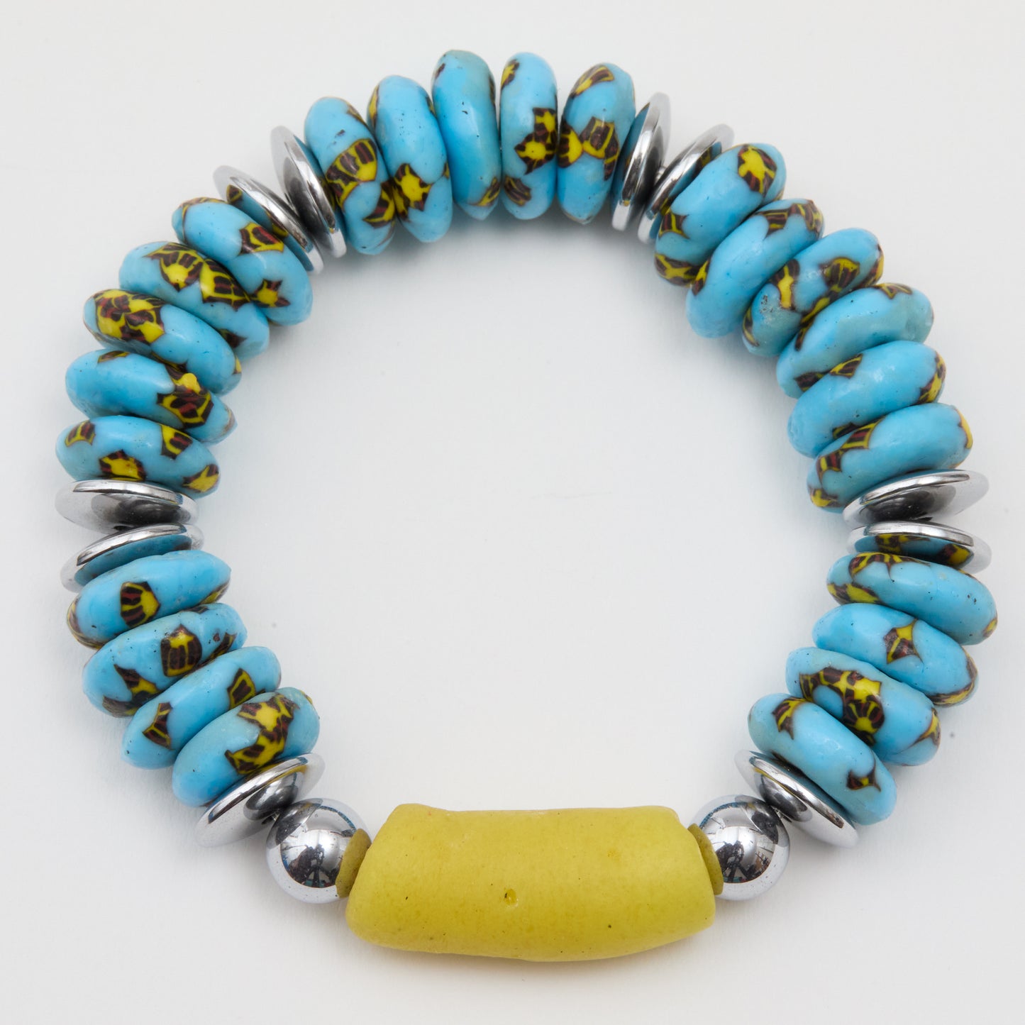Bracelet with blue beads, yellow accents, and silver accents on a white background