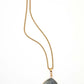 Necklace with a green stone pendant on a white background
