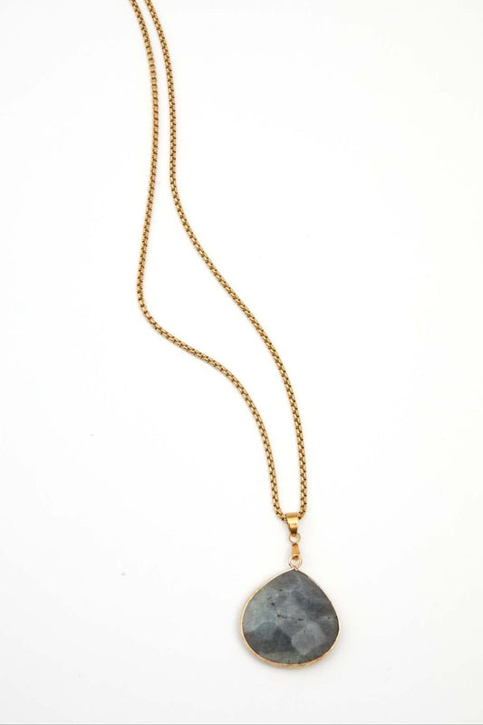 Necklace with a green stone pendant on a white background