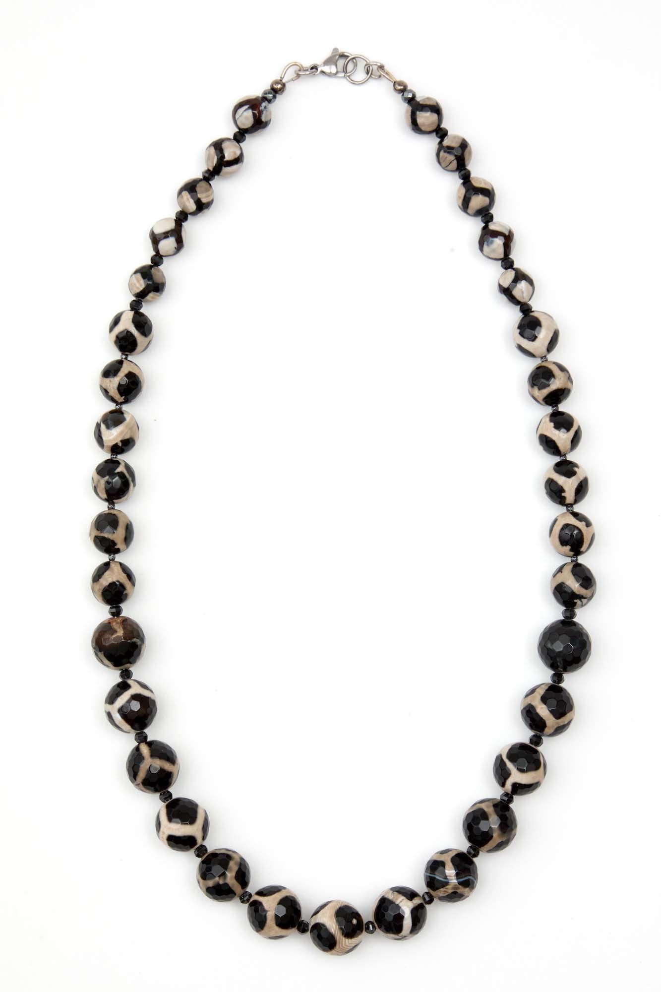 Necklace with black and white beads on a white background