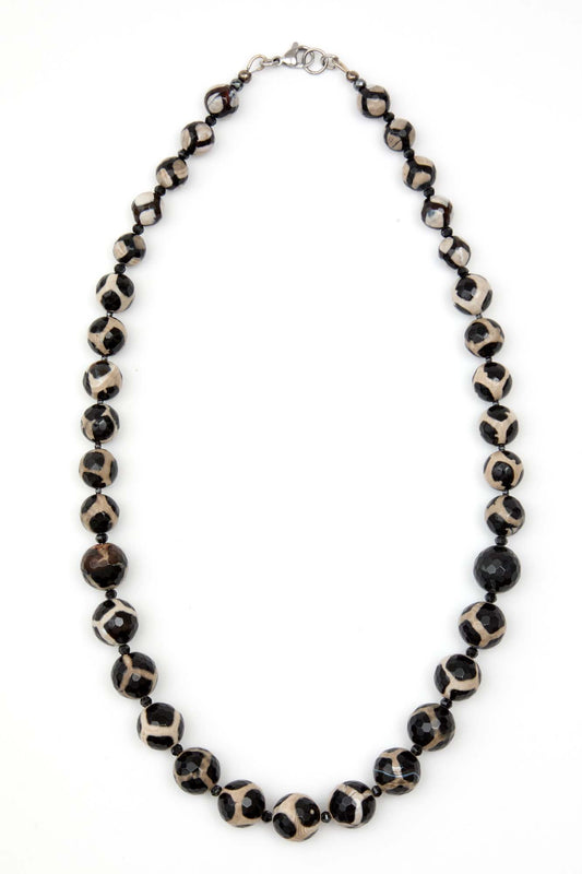 Necklace with black and white beads on a white background