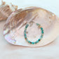 Beaded bracelet on a large shell with a white background