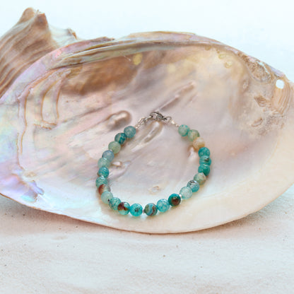 Turquoise beaded bracelet on a large shell