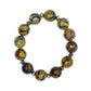 A bead bracelet with a combination of brown, black, and green faceted beads with hematite accents, against a white background. 